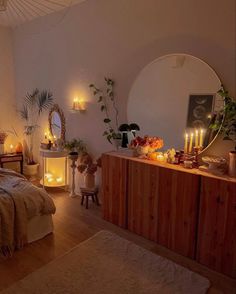 a bed room with a neatly made bed and lots of candles