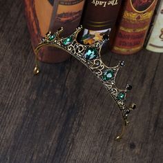 a tiara sitting on top of a wooden table next to books