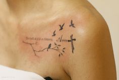 a woman with a cross and birds tattoo on her shoulder