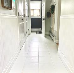 brown floor tiles painted white with floor paint; white tiled hallway leading to a powder room Painted Tile Floors, Candle Holder Makeover, Painting Floors, Paint Floor, Tiny Bath, Brown Tile, Floor Painting, Painting Tile Floors, Painted Tile