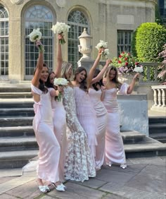 the bridesmaids are all wearing pink dresses and holding bouquets in their hands