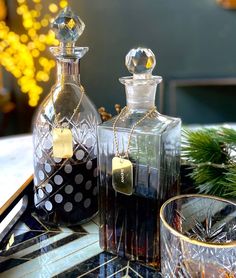 two glass bottles sitting on top of a table