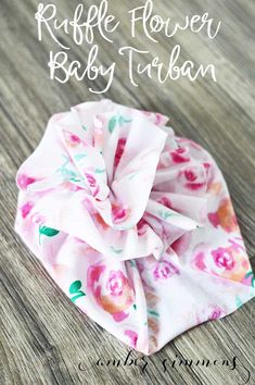 a pink flower baby turban on top of a wooden table with text overlay that says ruffle flower baby turban