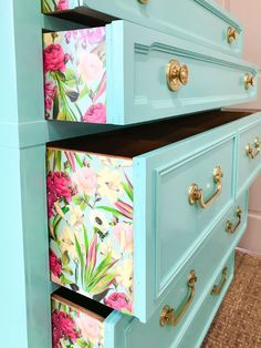 two drawers with flowers painted on them in the same color as they are next to each other