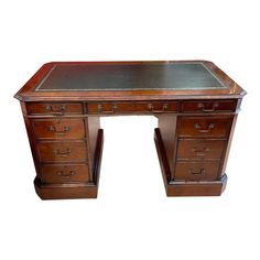 an old wooden desk with drawers and a glass top on the bottom shelf, isolated against a white background