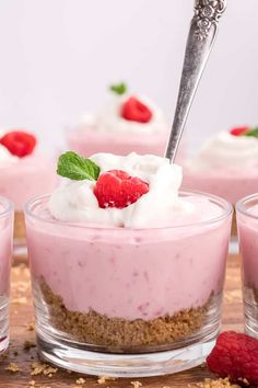 small desserts with strawberries and whipped cream in glass dishes on a wooden table