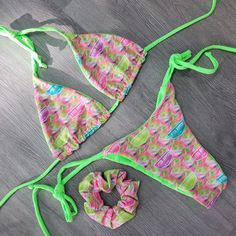 Introducing the Mariah LR Lime: a luxurious swimsuit collaboration between Lifted Rippers and BB Beekinis. Neon swirls Reversible to a solid Vibrant Lime, this fun design features tie traditional triangle top. Simple tie side bottoms with a scrunch in the butt! All reversible too! Set your style apart this season with a custom one of a kind Bikini! BOTTOM ONLY Top here Triangle Top Swimwear With Drawstring For Festival, Green Halter Neck Swimwear For Festivals, Vacation Triangle Top Swimwear With Drawstring, Summer Festival Swimwear With Drawstring, Green Triangle Top Swimwear With Drawstring, Green Tropical Swimwear For Festival, Green Stretch Festival Swimwear, Green Tie-side Bottom Swimwear For Festival, Green Tie-side Swimwear For Festivals