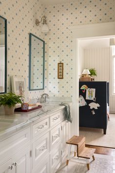 a bathroom with blue and white wall paper