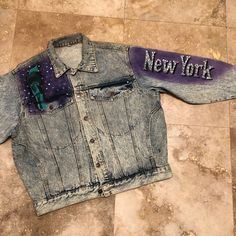 "Vintage 80s 90s NEW YORK Denim Jacket with the most amazing Details ONE ONLY DON'T MISS OUT LOVE ROCKS VINTAGE ITEM DETAILS & DESCRIPTION . Classic Denim Jacket - Biker, Motorcyle Style . Front Button . UnLined Label: Size: - refer to Measurements - NO RETURNS FOR NOT FITTING! Era: est. 1980s 1990s Color: Blue Denim - refer to Photographs Material: Denim Condition: Pre-Owned - Vintage - Very Good - expect Vintage wear & condition! This does have some soiling, refer to pictures. Refer to Vintage Denim Jacket With Graphic Print For Streetwear, Reworked Denim Jacket For Fall Streetwear, Fitted Retro Denim Jacket For Streetwear, 90s New York, Classic Denim Jacket, Love Rocks, Vintage Denim Jacket, Denim Coat Jacket, Big Apple