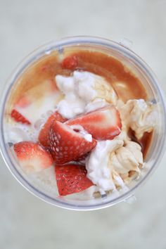 a cup filled with ice cream and strawberries