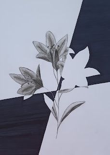 a black and white drawing of a flower on a piece of paper next to a wall