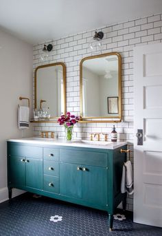 a bathroom with two sinks and mirrors on the wall next to each other in front of a white brick wall