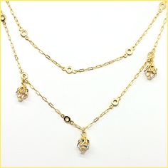 This beautiful necklace has a unique design - a very long chain that can be worn long or doubled, with the help of a toggle closure. It features tulip-shaped crystal drops set along half of the chain. Made of durable and beautiful 14kt gold-plated brass and enhanced with the finest European crystals. The full length is 42" or 20" when doubled. Made in the USA by La Vie Parisienne Elegant Double Strand Yellow Gold Charm Necklaces, Gold Drop Chain Necklaces, Elegant Gold Chain Dangle Charm Necklaces, Gold Long Drop Chain Necklaces, Gold Long Drop Chain Necklace, Elegant Drop Necklace With Chain Detail, Gold Dainty Drop Necklace With Cubic Zirconia, Gold Cubic Zirconia Drop Necklace, Elegant Gold-plated Double Chain Charm Necklaces