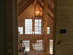 the inside of a house that is being built with wood framing and metal railings