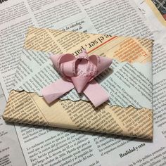 an origami bow on top of a newspaper