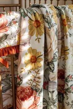 the back end of a chair with floral fabric draped over it's seat cushions