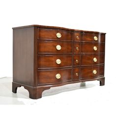 a wooden dresser with brass knobs on it's doors and drawer drawers, against a white background