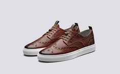 Business Slip-on Sneakers With Brogue Detailing, Luxury Brown Sneakers With Brogue Detailing, Leather Slip-on Sneakers With Brogue Detailing, Suede Sneakers With Leather Sole, Closed Toe, Brown Suede Slip-on Sneakers With Rubber Sole, Luxury Sneakers