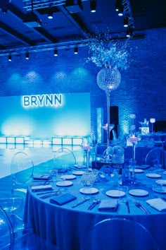 a table set up for an event with blue lighting