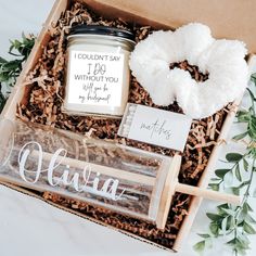 an open box with some items in it that include a candle, donut and more