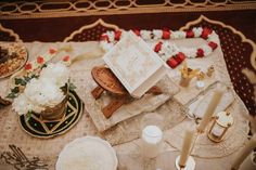 a table topped with lots of different types of cakes and desserts on top of it