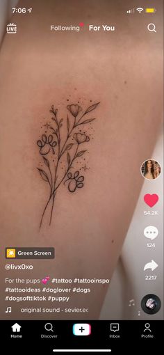 a small flower tattoo on the back of a woman's left shoulder and chest