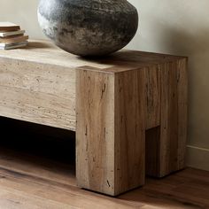 a stone bowl sitting on top of a wooden table