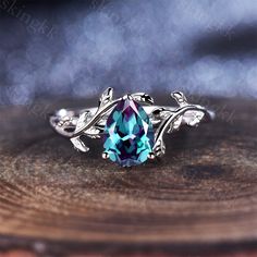 a blue ring with leaves on it sitting on top of a wooden table