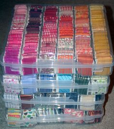 several plastic containers filled with different colored thread