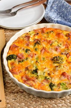 a casserole dish with ham and broccoli in it