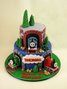 a thomas the train birthday cake with trees on top