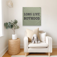 a living room with a white chair and a green sign on the wall that says long live boyhood