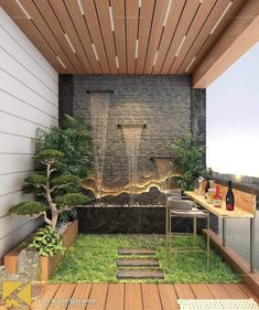 an outdoor living area with wood flooring and stone wall, surrounded by greenery