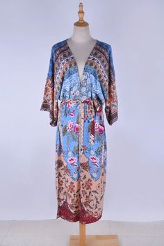 Channel your bohemian spirit with the Aina Boho Kimono. Made of cotton and rayon, its tropical flower pattern and batwing sleeves give off a relaxed vibe. Plus, the matching belt adds a touch of chic to this quirky piece. Don't settle for basic, unleash your inner free-spirited fashionista. Specs: Material: Cotton, Rayon ONE SIZE Fits ALL Bohemian V-neck Kaftan For Brunch, Casual V-neck Kimono With Boho Print, Spring V-neck Kimono With Belt, V-neck Patterned Kimono For Festival, Bohemian Summer Kaftan For Brunch, Chic Floral Print Kimono For Vacation, Chic Multicolor Floral Print Kimono, Chic Floral Print Kaftan With Kimono Sleeves, Chic Flowy Floral Print Kimono