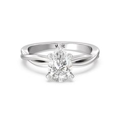 a white gold engagement ring with an oval cut diamond in the center and twisted band