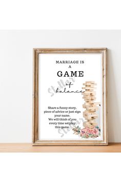 a wooden frame with the words marriage is a game on it and an image of a stack