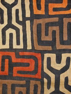 an orange, brown and black pattern on fabric