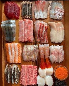 an assortment of meats and seasonings laid out on a cutting board