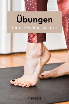 a woman standing on top of a yoga mat with her feet up in the air