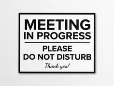 a black and white sign that says meeting in progress please do not disturb thank you