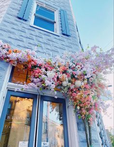 flowers are growing on the side of a building