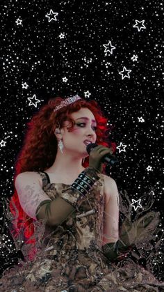 a woman with red hair wearing a tiara and holding a microphone in front of stars