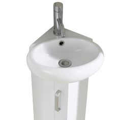 a white pedestal sink with a chrome faucet