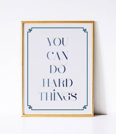 an art print with the words you can do hard things in blue and gold frame