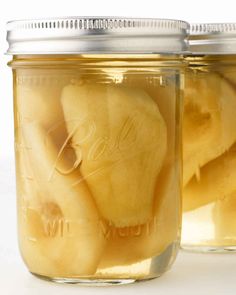 two jars filled with sliced bananas sitting next to each other