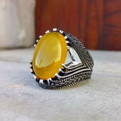 The ring is made of 925 sterling silver, decorated with stunning yellow zircon stone. PRODUCT FEATURES -Products are shipped with free shipping along with the box and bag. - Production Mine: 925 Sterling Silver - Weight: 15,5 grams - Stone: Yellow Zircon -Stone size: 15x20 mm All products come in a special gift box. If you don't see your size, please ask, we can produce your size. You are looking at high quality handcrafted silver ring. All our products are designed and produced by ourselves. Yo Luxury Handmade Yellow Rings, Precious Stones Rings, Men's Ring, Onyx Stone, Men's Rings, Stone Ring, Stone Rings, Precious Stones, Onyx