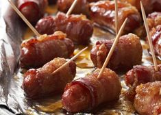 several skewered meats on tin foil with toothpicks