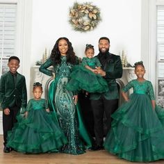 the family is dressed in green for christmas