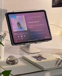 a desktop computer monitor sitting on top of a desk next to a cup and pen