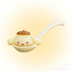 a teapot shaped like a cat with a spoon sticking out of it's mouth